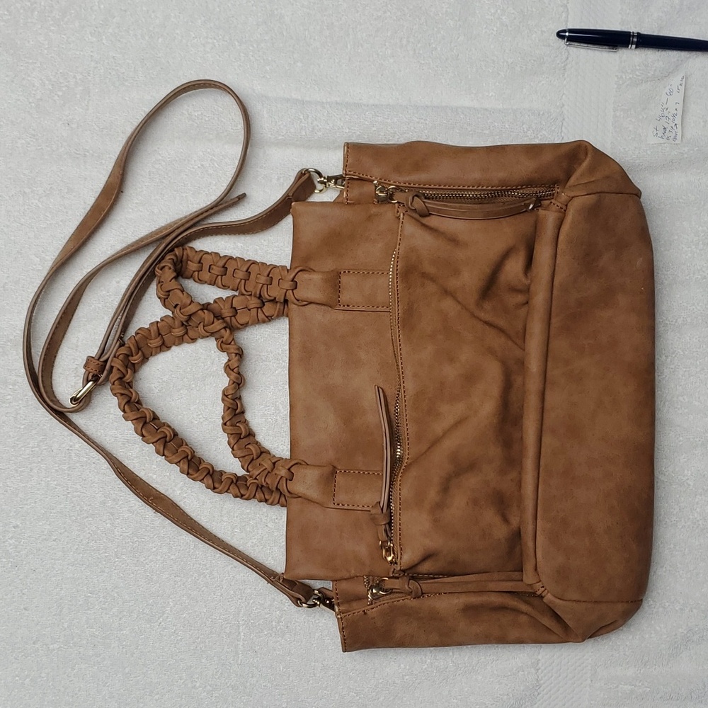 Tan polyurethane roomy purse with many pockets. Detachable shoulder stap.